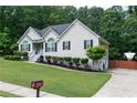 Well-maintained home featuring a manicured lawn, long driveway, side-entry garage, and RV parking at 128 Champion Way, Hiram, GA 30141