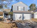 Front exterior of a two-story house with a two-car garage and a nicely maintained lawn at 2540 Park Ave, Austell, GA 30106