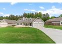 Inviting home showcasing well-kept grounds, a classic design, and an attached two-car garage at 31 Copper Leaf Ct, Villa Rica, GA 30180