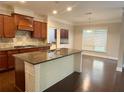 Well-equipped kitchen island with granite countertops, stainless steel sink, and stylish wood cabinetry at 139 Vinca Cir, Suwanee, GA 30024