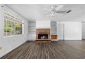 Inviting living room featuring a brick fireplace, built-in shelves, and large windows at 315 Pleasant Grove Rd, Mcdonough, GA 30252