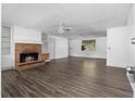 Bright living room with a brick fireplace, built-in shelving, and stylish flooring at 315 Pleasant Grove Rd, Mcdonough, GA 30252