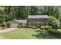 Beautiful two-story brick home with a well-maintained lawn, blue shutters, and a bright yellow door at 3287 Alton Rd, Atlanta, GA 30341