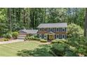 Attractive two-story brick home featuring a lush front yard, manicured landscaping, and a two-car garage at 3287 Alton Rd, Atlanta, GA 30341