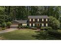 Elegant two-story brick house with green lawn, neat landscaping and a two car garage at 3287 Alton Rd, Atlanta, GA 30341