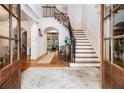 Elegant foyer featuring hardwood floors, a grand staircase, and an arched entryway at 3809 Wieuca Ne Rd, Atlanta, GA 30342