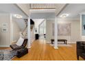 Spacious living room featuring hardwood floors, elegant columns, and a bright open floor plan at 530 Twinflower Ct, Roswell, GA 30075