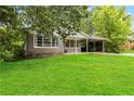 Quaint single-story home surrounded by mature trees and a well-manicured lawn at 1176 Cardinal Ne Rd, Conyers, GA 30012