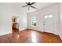 Sunlit living room with hardwood floors and an open doorway to the updated kitchen at 3288 Dogwood St, Atlanta, GA 30337