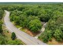 Breathtaking aerial view of the property nestled among mature trees and lush landscaping at 5535 Dorsett Shoals Rd, Douglasville, GA 30135