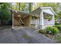 View of the carport with a cozy front porch including charming decorations at 118 Lucia Dr, Smyrna, GA 30082