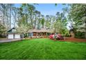 Beautiful home with lush lawn, flowering trees, and a detached garage, offering serene suburban living at 1691 Whitlock Rd, Marietta, GA 30066