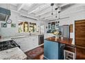 Bright kitchen features white cabinetry, granite countertops, stainless steel appliances, and a cozy island at 1691 Whitlock Rd, Marietta, GA 30066