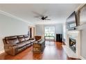 Cozy living room featuring hardwood floors, a fireplace, and comfortable seating at 1360 Stampmill Way, Lawrenceville, GA 30043