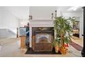 Cozy room featuring a decorative fireplace, a wooden mantel, and an ornate screen at 1620 Cedar Hl, Douglasville, GA 30134