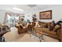 Living room featuring a plush sofa, decorative pillows, and a large window at 1620 Cedar Hl, Douglasville, GA 30134