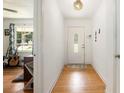 Bright foyer with hardwood floors, featuring a decorative light fixture and a glimpse into the living room at 3055 Henderson Mill Rd, Atlanta, GA 30341