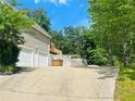 Long driveway leading to a two-car garage and backyard at 107 Oconnor Dr, Dallas, GA 30157