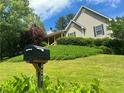 Well-manicured front yard and inviting covered front porch at 107 Oconnor Dr, Dallas, GA 30157