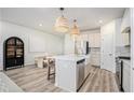 Open-concept kitchen with island, modern cabinetry, stainless steel appliances, and stylish pendant lighting at 1704 Hyssop Se Blvd, Smyrna, GA 30126