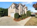 Spacious home featuring a large driveway, side-entry garage, and professionally landscaped front yard at 2577 Ozella Sw Pl, Atlanta, GA 30331