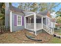 Side view of a cute grey home with purple shutters and a cozy front porch at 1686 Alvarado Sw Ter, Atlanta, GA 30310