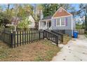 A charming home featuring a well-kept lawn and a classic picket fence at 1686 Alvarado Sw Ter, Atlanta, GA 30310