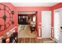 Welcoming entryway showcases a large wall clock, beautiful wood floors, and views into the adjacent living room at 1801 Deer Crossing Cir, Jonesboro, GA 30236