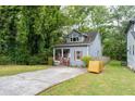 Cozy home with inviting curb appeal, lush trees, and plenty of parking at 3111 Jones St, East Point, GA 30344