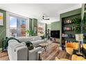 Stylish living room featuring a plush sofa, modern decor, city views, built-in shelves, and hardwood floors at 57 Forsyth Nw St # 11G, Atlanta, GA 30303