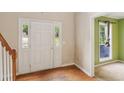 Bright entryway featuring hardwood floors, white door with sidelights, and adjacent room at 111 Trellis Ct, Acworth, GA 30101