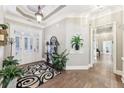 Elegant foyer with hardwood floors, decorative rug, stylish console table, and glass-paneled front doors at 270 Morrow Rd, Newborn, GA 30056