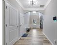 Entry hallway features hardwood floors, archway, white trim, and tall ceilings at 4251 Haywater Cv, Buford, GA 30519