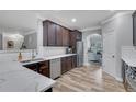 Modern kitchen with stainless steel appliances, white subway tile, and dark wood cabinets at 4251 Haywater Cv, Buford, GA 30519
