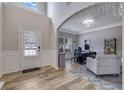 Bright living room with hardwood floors, wainscoting, transom window, and natural light at 4251 Haywater Cv, Buford, GA 30519