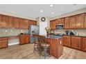 Well-equipped kitchen with wooden cabinets, granite countertops, and stainless steel appliances at 590 Kyle Trace Ct, Sugar Hill, GA 30518