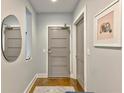 Modern entryway with gray door, hardwood floors and mirror at 1100 Howell Mill Nw Rd # 312, Atlanta, GA 30318