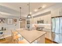 Bright kitchen with quartz countertops, stainless steel appliances, and island with bar stool seating at 1100 Howell Mill Nw Rd # 312, Atlanta, GA 30318
