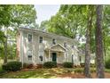Charming two-story traditional home with a manicured lawn and mature trees providing shade at 1404 Vernon North Dr, Dunwoody, GA 30338