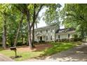 Charming two-story traditional home with a manicured lawn, mature trees, and a long driveway at 1404 Vernon North Dr, Dunwoody, GA 30338