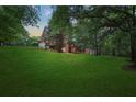 Expansive backyard with lush greenery and mature trees, perfect for outdoor activities at 239 Berry Rd, Mcdonough, GA 30252