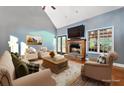 Cozy living room featuring a fireplace, vaulted ceilings, and ample natural light at 239 Berry Rd, Mcdonough, GA 30252