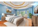Comfortable bedroom with tray ceilings, lots of natural light, and hardwood floors at 239 Berry Rd, Mcdonough, GA 30252