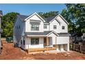 Charming two-story home with white siding, black framed windows, and a welcoming front porch at 278 1St Ave, Avondale Estates, GA 30002