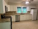 Well-lit kitchen with granite countertops, stainless steel appliances, and bright white cabinetry at 2934 Union Grove Rd, Conyers, GA 30012