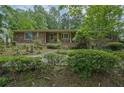 Charming brick home with a mix of stone accents and lush greenery at 648 Cativo Sw Dr, Atlanta, GA 30311