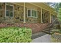 Inviting front porch with stone accents and brick stairs, adding character to the home's facade at 648 Cativo Sw Dr, Atlanta, GA 30311