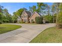 Beautiful brick home with attached garage and large concrete driveway at 1750 Providence Place Dr, Alpharetta, GA 30009