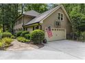 Spacious home features a two-car garage with a basketball hoop and an American flag at 960 Lost Forest Dr, Sandy Springs, GA 30328