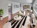 Bright living room with hardwood floors, neutral decor, and modern furniture arrangement at 710 Montclair Sw Dr, Smyrna, GA 30082